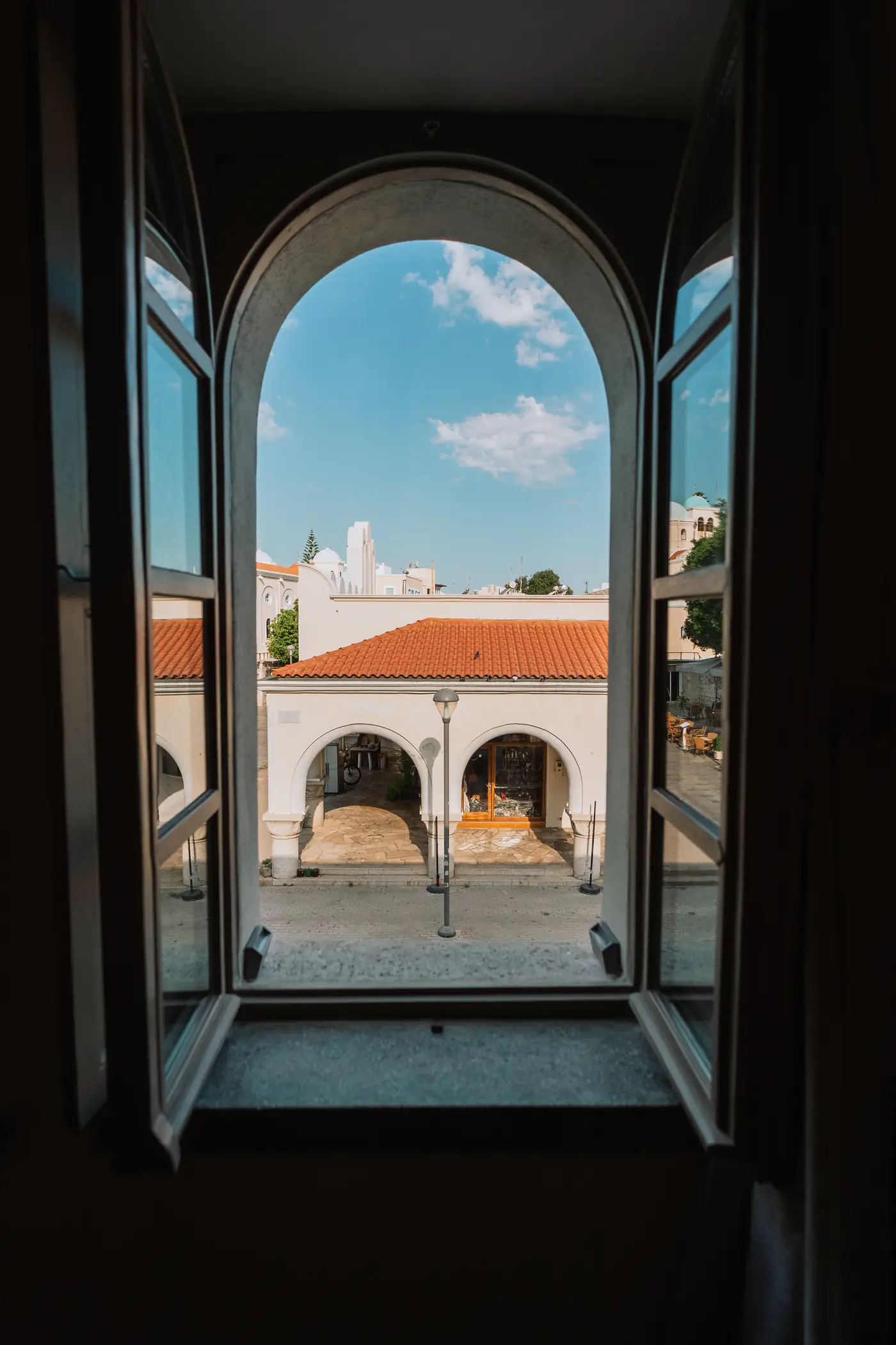 Τοξωτό δίφυλλο παράθυρο με θέα στη στοά